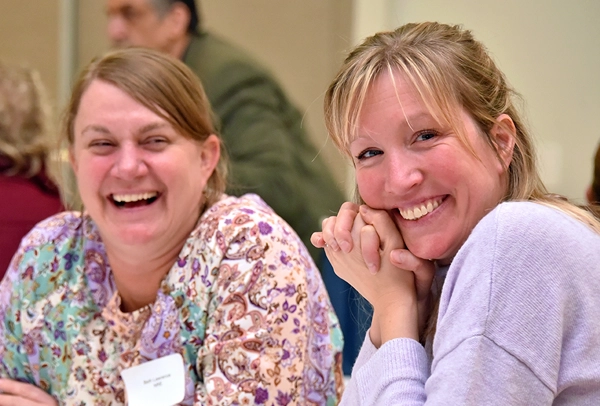 Two happy faculty members smiling for photo.