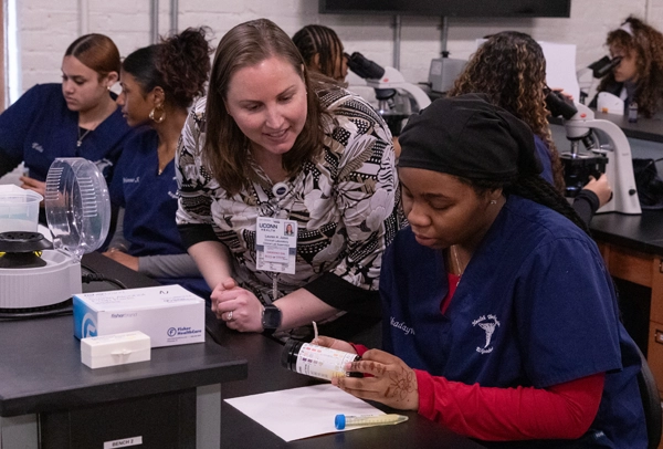 UConn Faculty member assisting student with assignment.